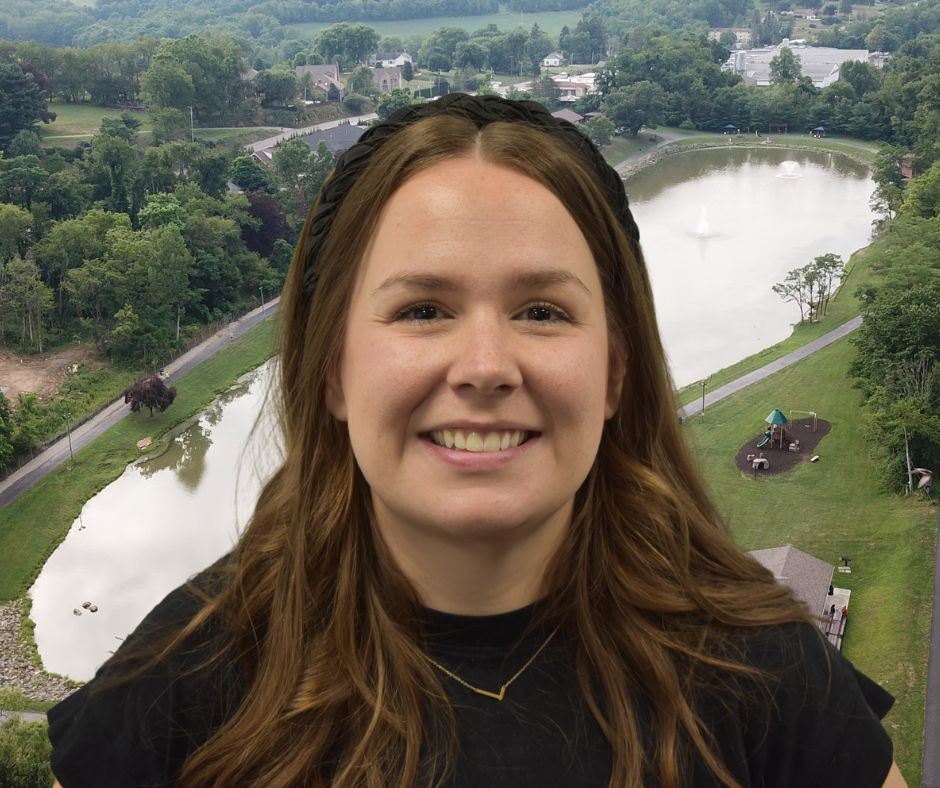 New Parks & Recreation Coordinator with Indian Lake Park in the background